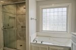 Master bathroom with tub and walk in shower
